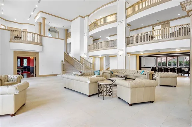 a living room with furniture and kitchen view