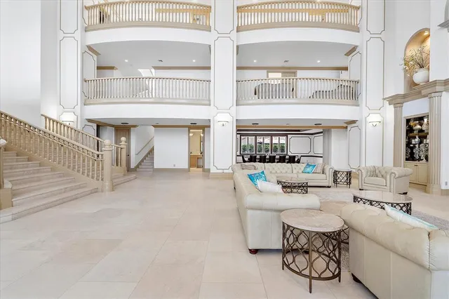 a large white kitchen with a large window and stainless steel appliances