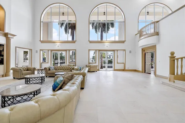 a kitchen with stainless steel appliances granite countertop a dining table chairs and a chandelier