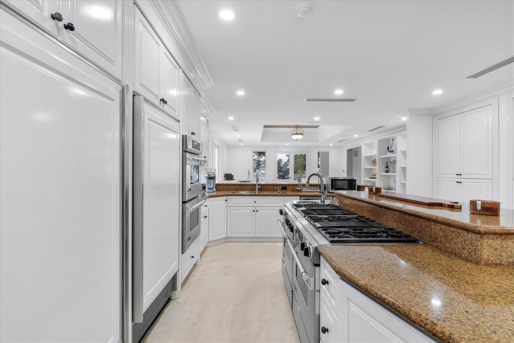 414 Riviera Isle Drive Fort Lauderdale, FL 33301 - Photo 23 of 70 a kitchen with stainless steel appliances granite countertop a refrigerator and a sink