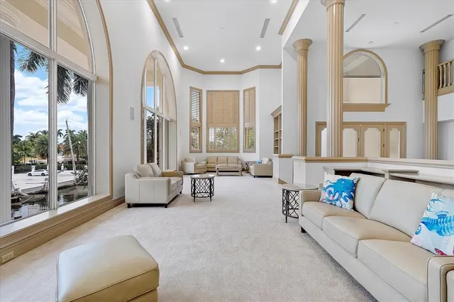 a living room with furniture and a floor to ceiling window