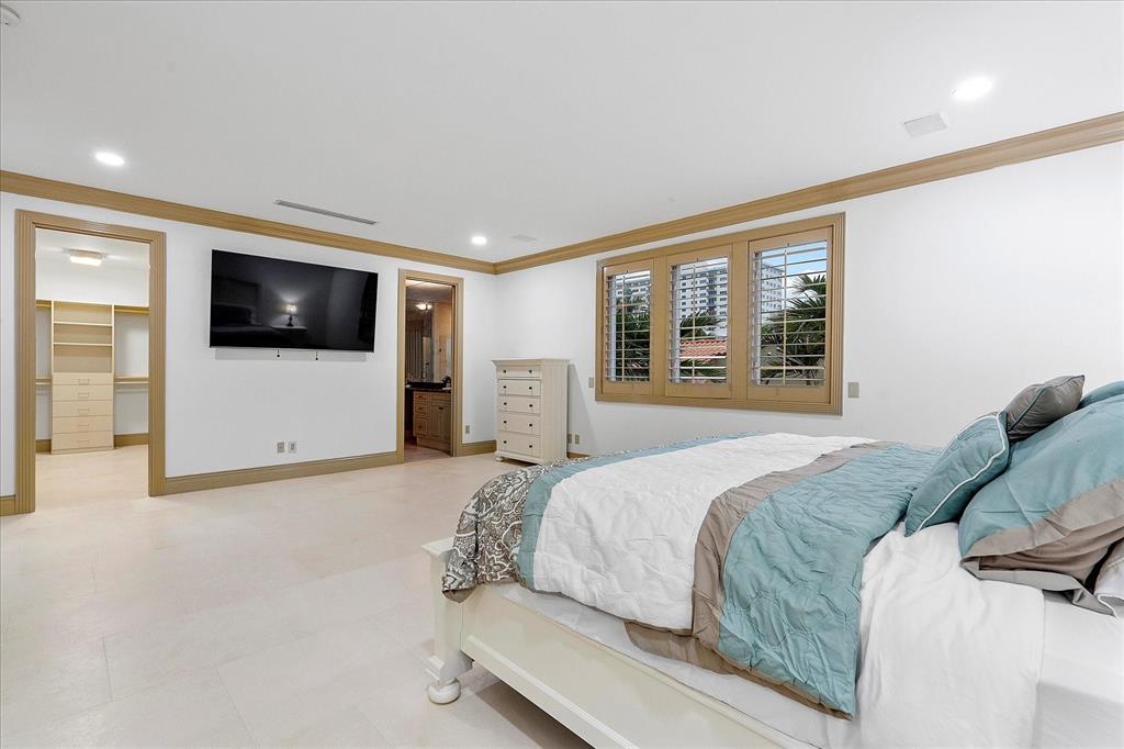 414 Riviera Isle Drive Fort Lauderdale, FL 33301 - Photo 38 of 70 a spacious bedroom with a large bed and a flat screen tv