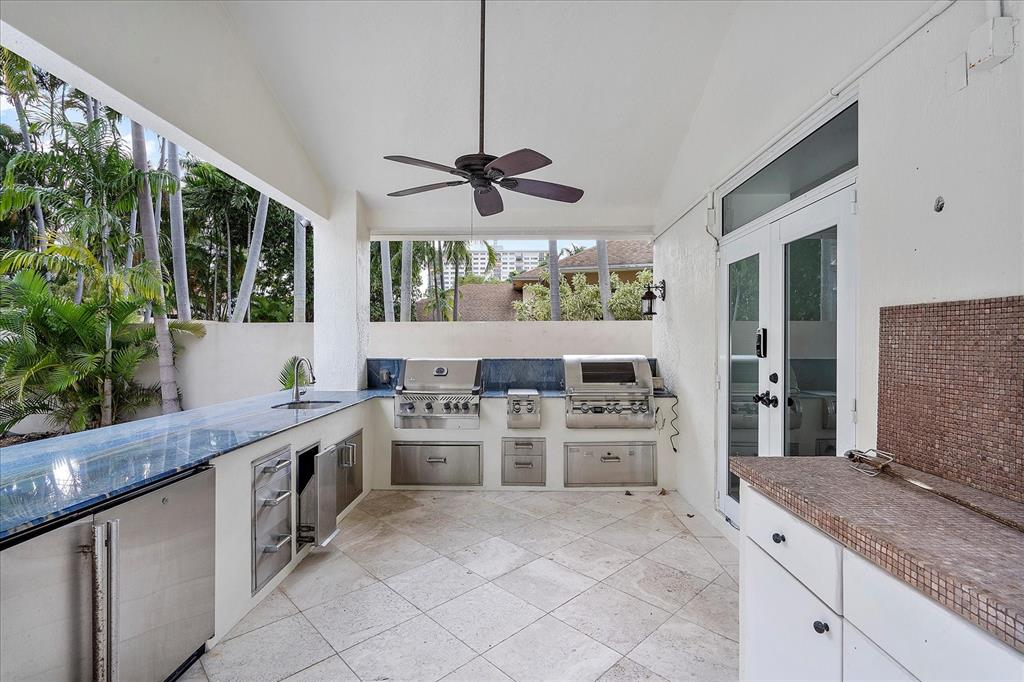 414 Riviera Isle Drive Fort Lauderdale, FL 33301 - Photo 46 of 70 a kitchen with stainless steel appliances granite countertop a stove a sink and a refrigerator