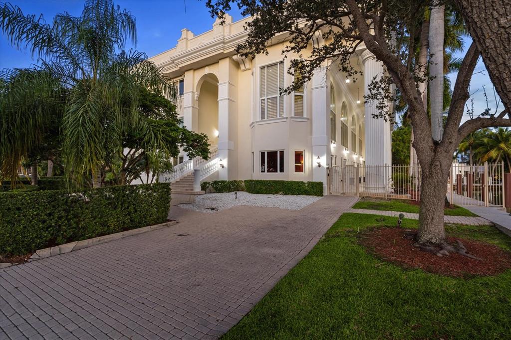 414 Riviera Isle Drive Fort Lauderdale, FL 33301 - Photo 69 of 70 a front view of a house with a yard and tree
