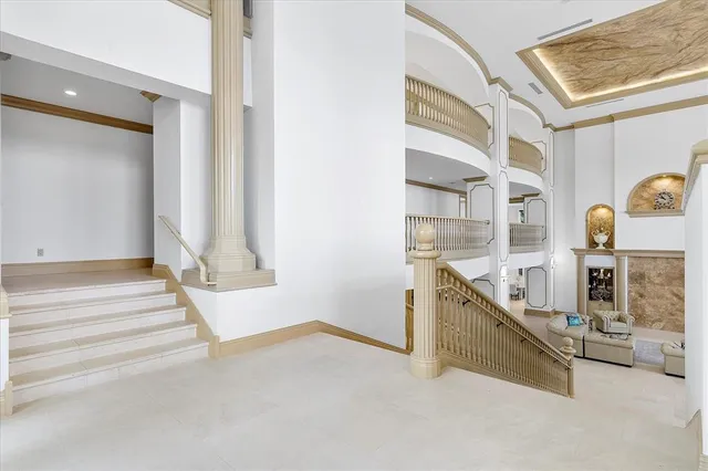 a living room with fireplace furniture and a large window