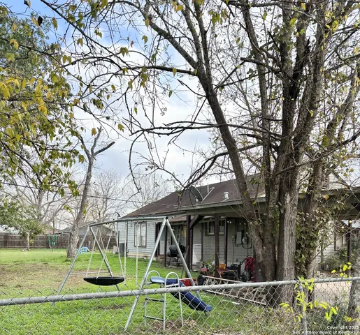 a view of a house with backyard porch and sitting area