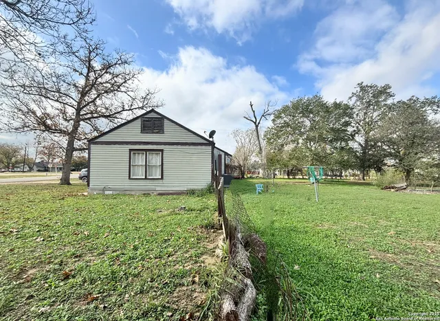 a view of a house with yard and tree s