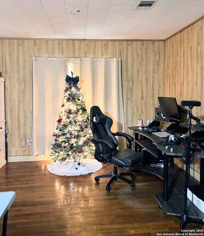 a view of a workspace with furniture and a window