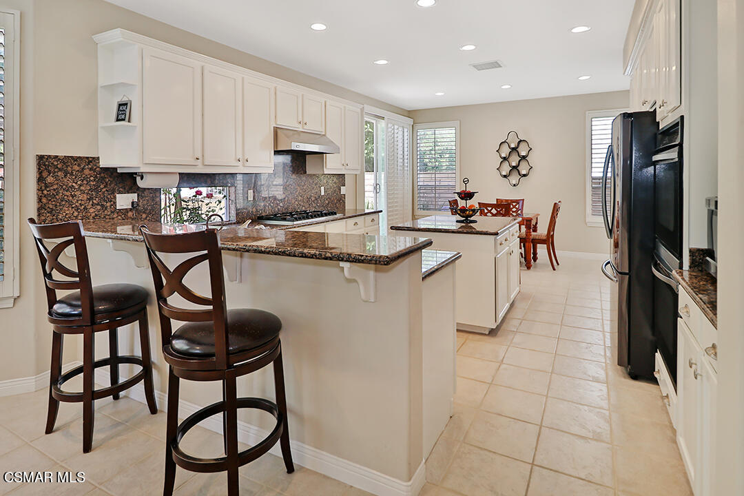 151 Brooks Road Simi Valley, CA 93065 - Photo 22 of 56 a kitchen with stainless steel appliances granite countertop a stove a sink and a refrigerator