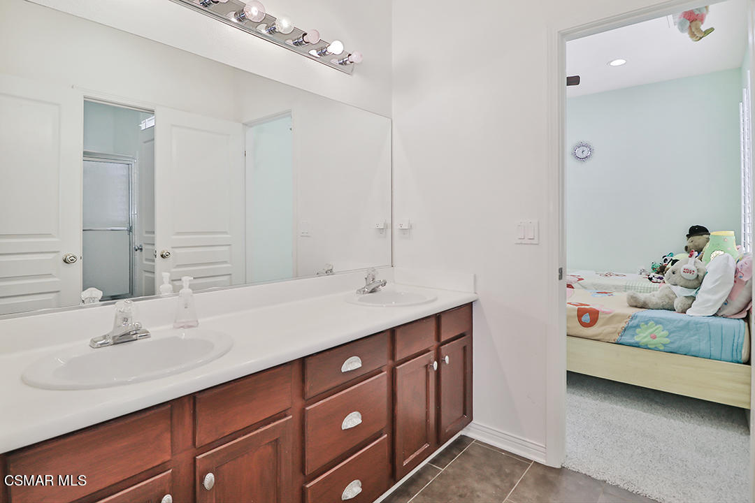 151 Brooks Road Simi Valley, CA 93065 - Photo 40 of 56 a bathroom with a double vanity sink and a mirror