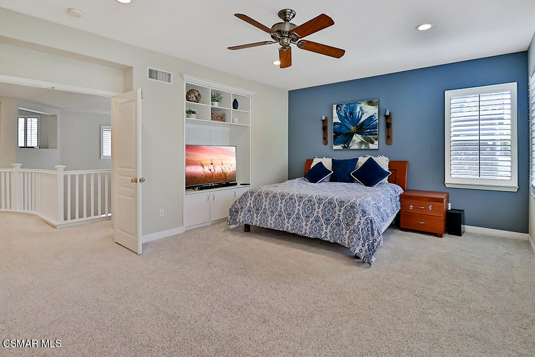 151 Brooks Road Simi Valley, CA 93065 - Photo 44 of 56 a bedroom with a bed and a chandelier