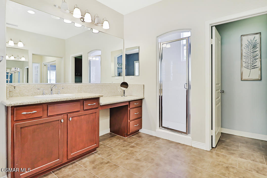 151 Brooks Road Simi Valley, CA 93065 - Photo 50 of 56 a spacious bathroom with a granite countertop sink a toilet a mirror and shower