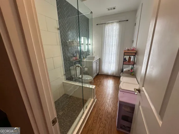 a view of a hallway with furniture and front door