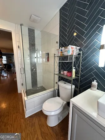 a bathroom with a toilet and a shower