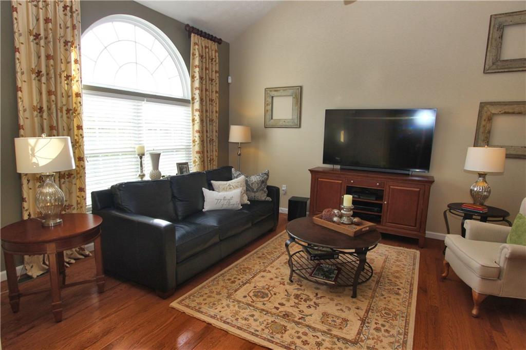 Living room with neutral paint, hardwood floors and lots of natural light!