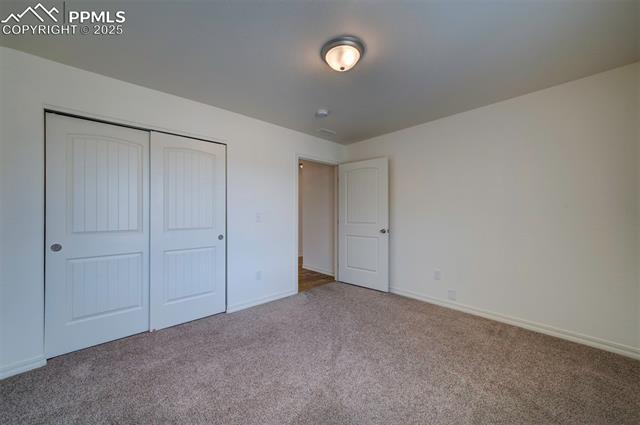 6604 Watusi Road Peyton, CO 80831 - Photo 28 of 40 Unfurnished bedroom featuring carpet floors and a closet