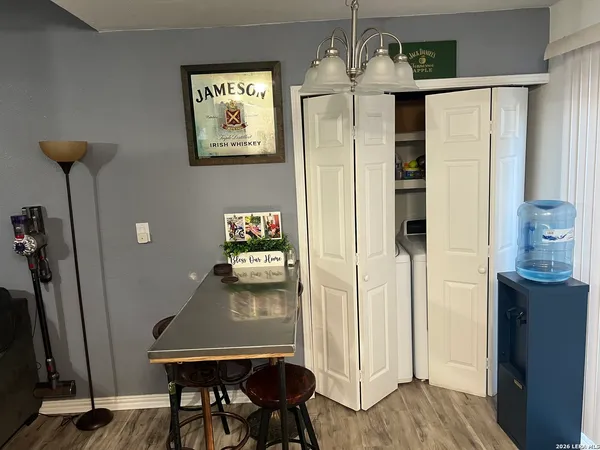 a view of a hallway with furniture and wooden floor
