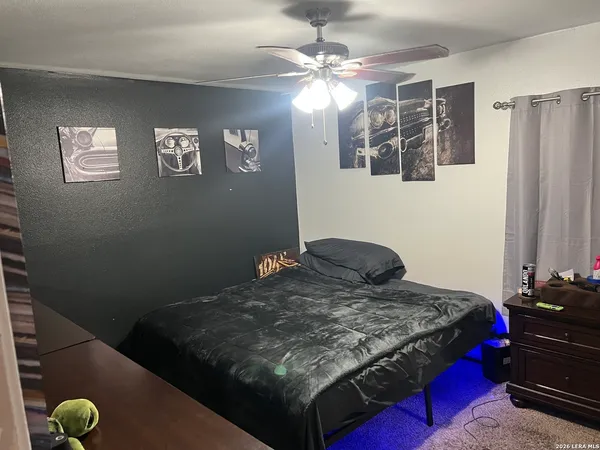 a bedroom with a bed and dresser