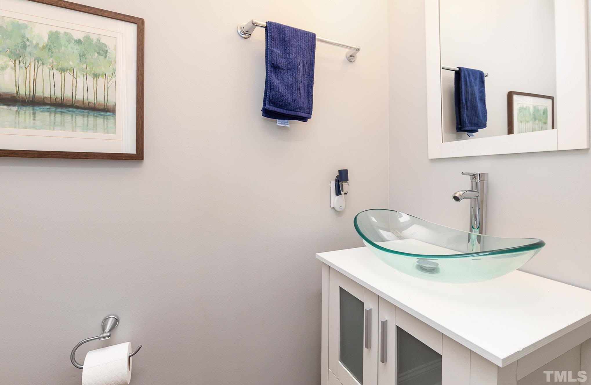 5333 Bartram Place Raleigh, NC 27617 - Photo 13 of 24 a bathroom with a sink and a mirror