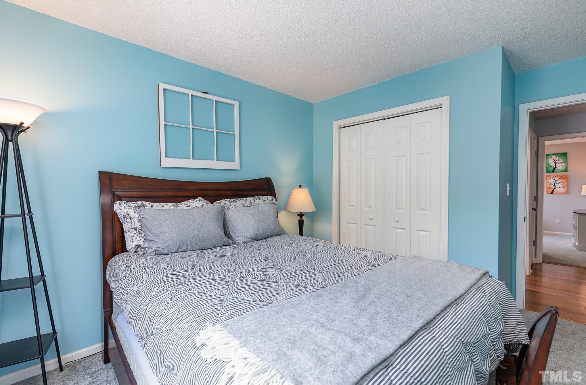 5333 Bartram Place Raleigh, NC 27617 - Photo 18 of 24 a bedroom with a bed and window