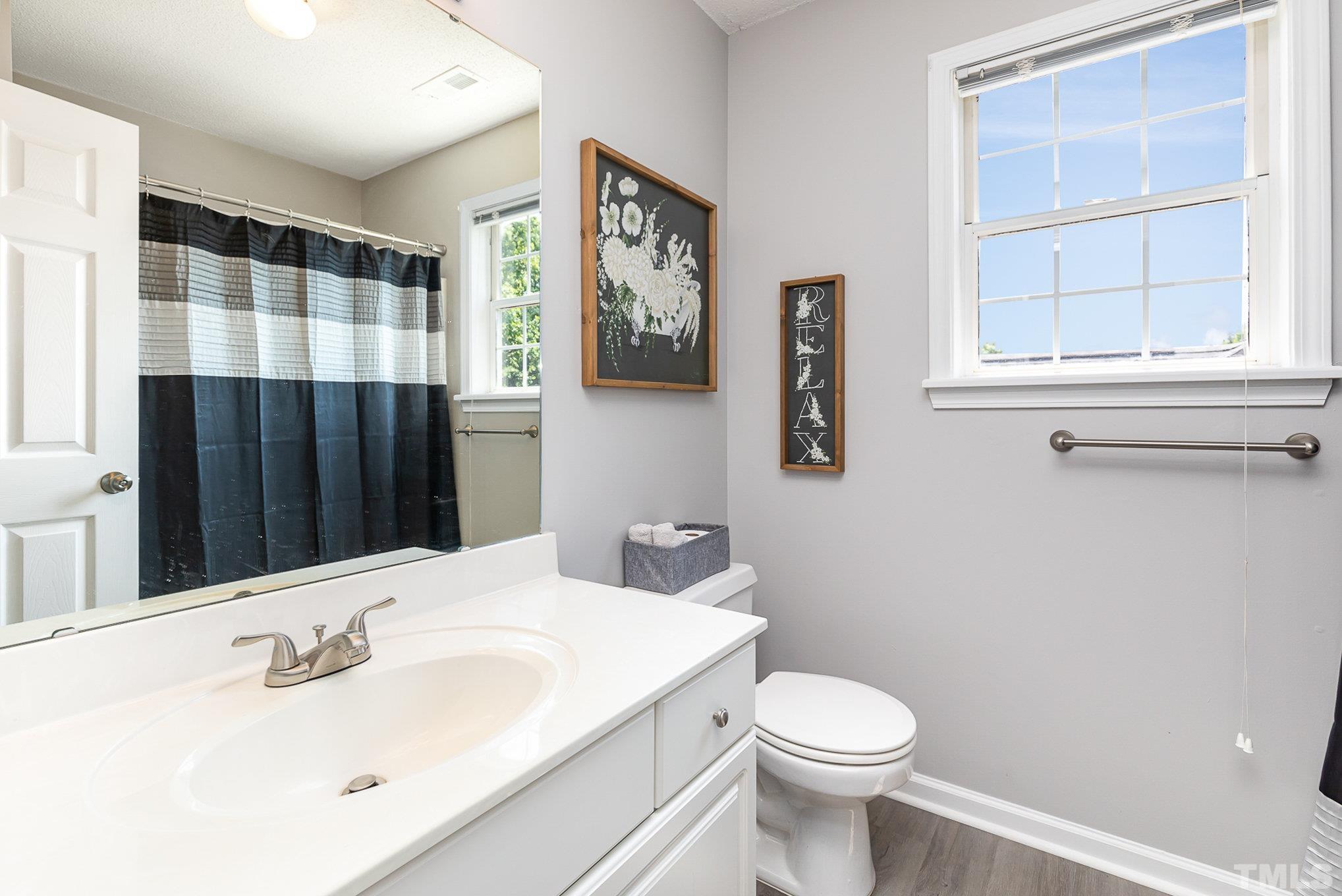 5333 Bartram Place Raleigh, NC 27617 - Photo 19 of 24 a bathroom with a sink and a toilet