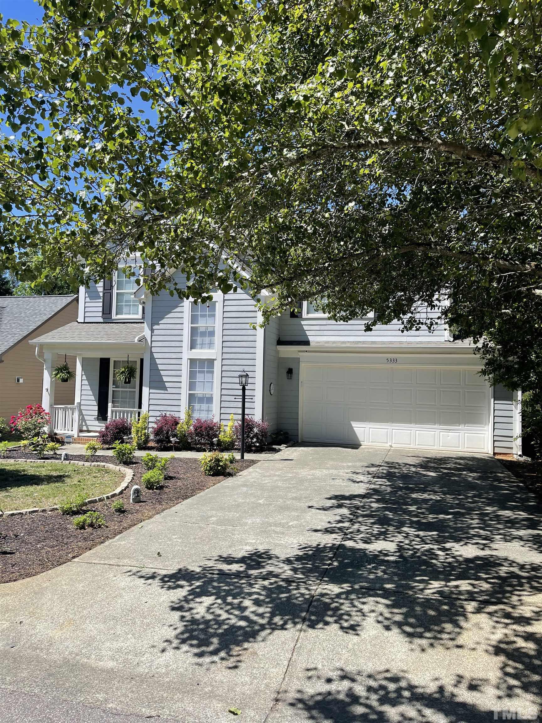5333 Bartram Place Raleigh, NC 27617 - Photo 4 of 24 a front view of house with yard and trees in the background