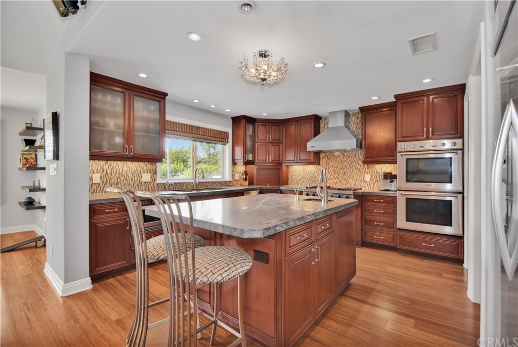22 Hillcrest Manor Rolling Hills Estates, CA 90274 - Photo 14 of 54 a kitchen with stainless steel appliances granite countertop a stove top oven a sink and a refrigerator
