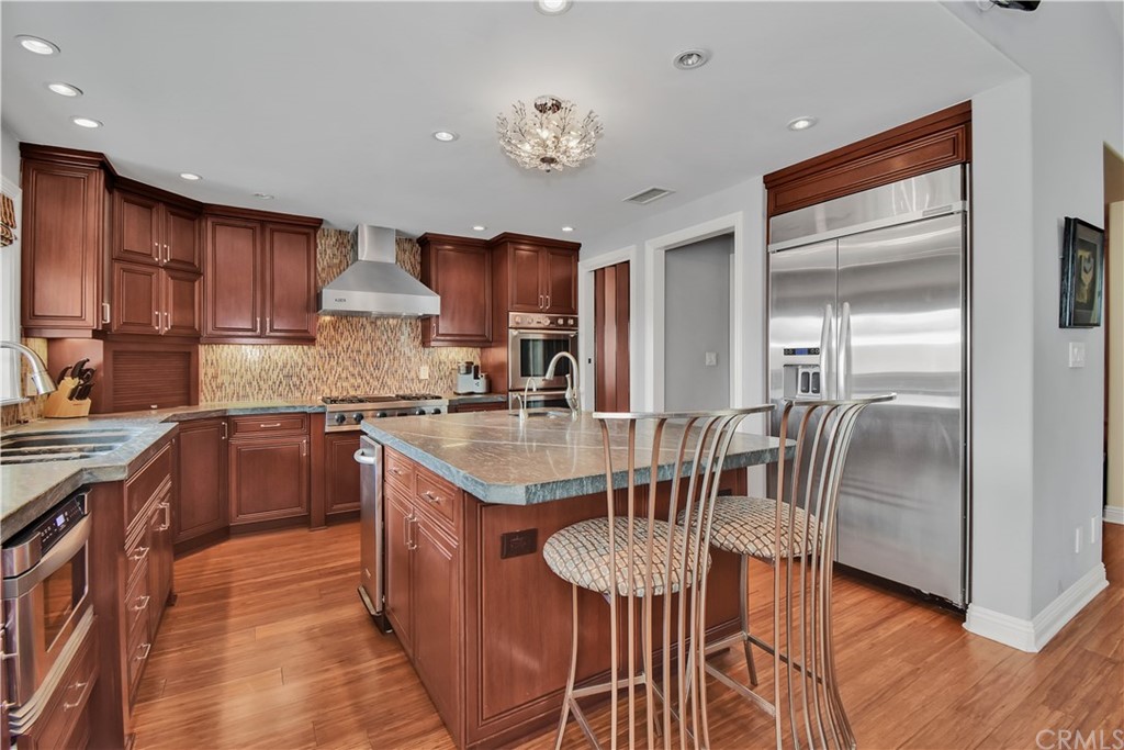 22 Hillcrest Manor Rolling Hills Estates, CA 90274 - Photo 15 of 54 a kitchen with stainless steel appliances granite countertop a sink a stove a refrigerator and island