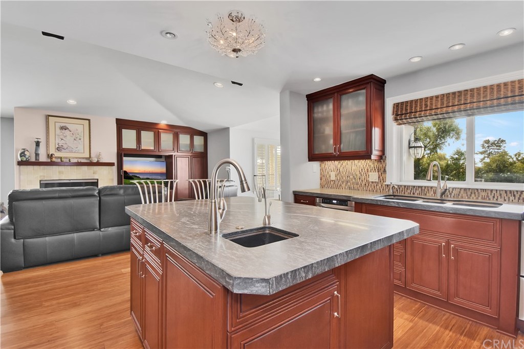 22 Hillcrest Manor Rolling Hills Estates, CA 90274 - Photo 16 of 54 a kitchen with stainless steel appliances granite countertop a sink dishwasher and a stove with wooden floors