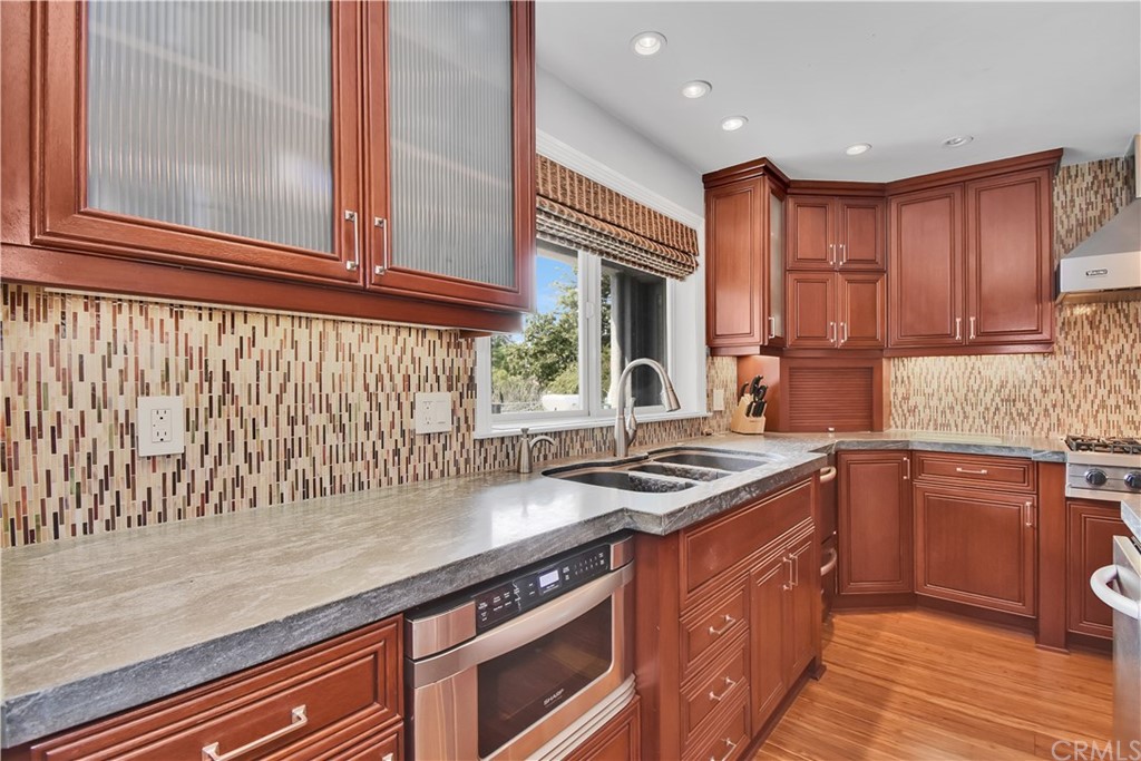 22 Hillcrest Manor Rolling Hills Estates, CA 90274 - Photo 18 of 54 a kitchen with stainless steel appliances granite countertop a stove a sink and a microwave