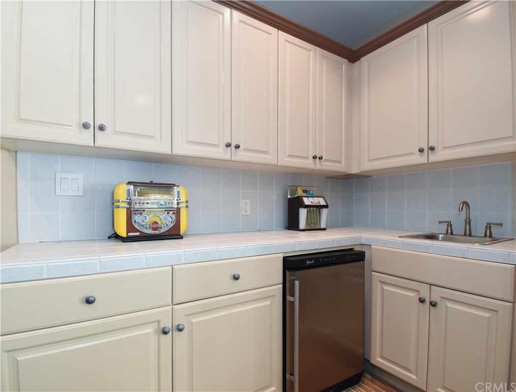 22 Hillcrest Manor Rolling Hills Estates, CA 90274 - Photo 33 of 54 a kitchen with white cabinets and white appliances