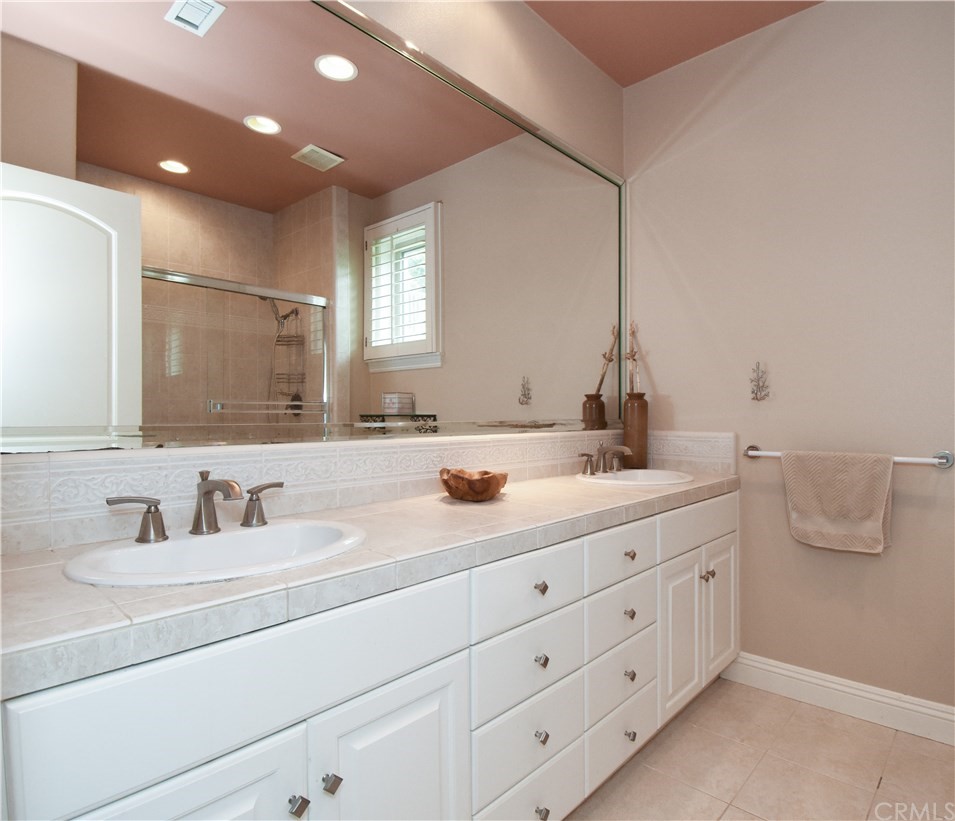 22 Hillcrest Manor Rolling Hills Estates, CA 90274 - Photo 38 of 54 a bathroom with a double vanity sink and mirror