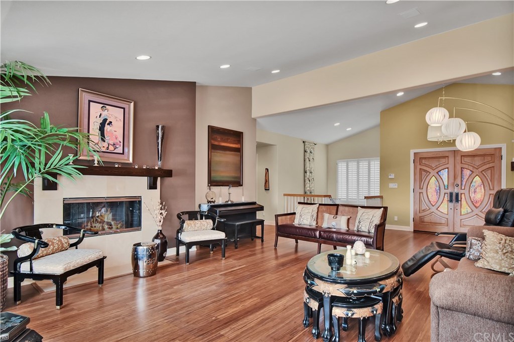 22 Hillcrest Manor Rolling Hills Estates, CA 90274 - Photo 7 of 54 a living room with furniture a fireplace and a potted plant
