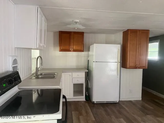 a utility room with wooden floor washer and dryer