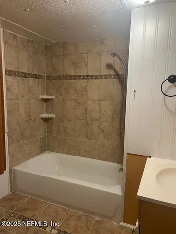 a bathroom with a shower and a bath tub