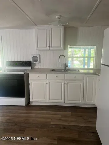 a kitchen with stainless steel appliances granite countertop a sink dishwasher a stove and a microwave oven with cabinets