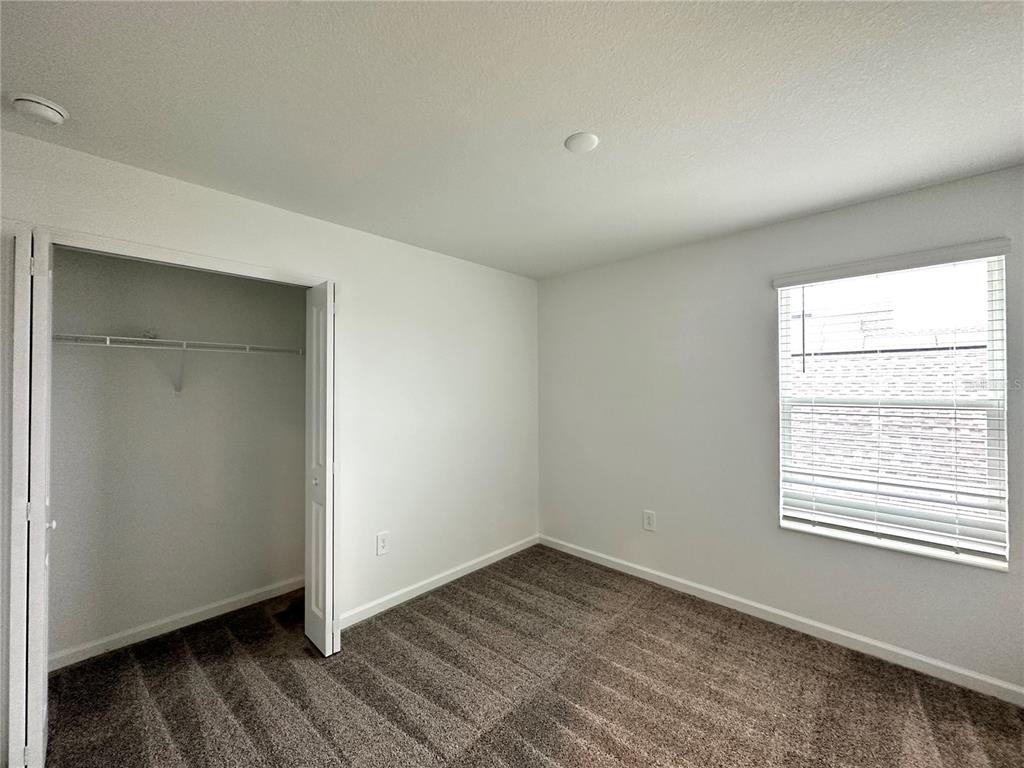 1784 Foreman Road Eagle Lake, FL 33839 - Photo 21 of 24 an empty room with wooden floor and windows