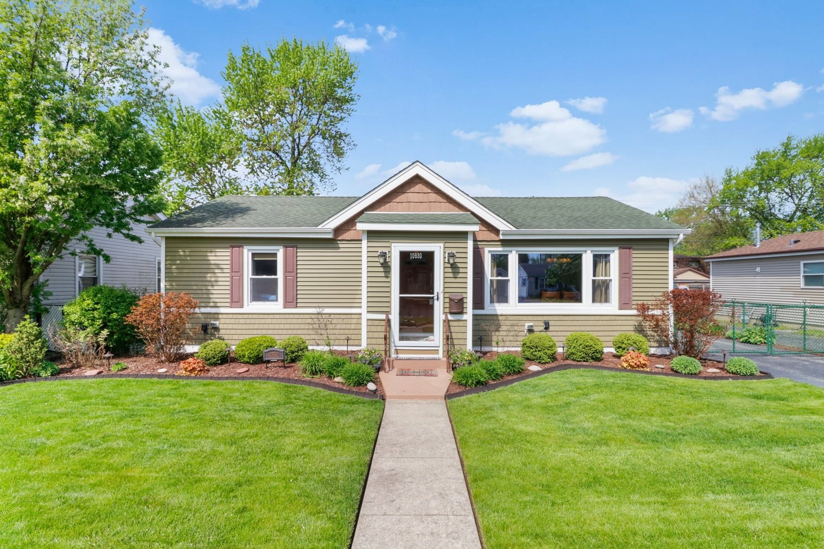 10930 Oak Avenue Chicago Ridge, IL 60415 - Photo 1 of 20 a front view of a house with a garden and plants