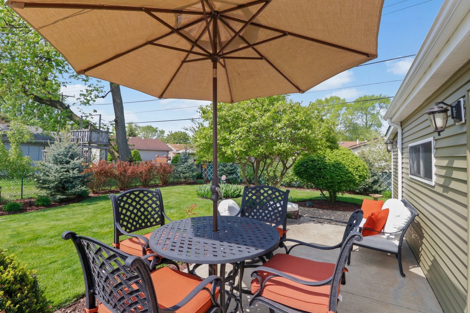 10930 Oak Avenue Chicago Ridge, IL 60415 - Photo 16 of 20 a patio with a table and chairs under an umbrella
