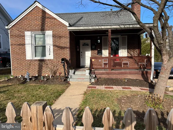 a front view of a house with garden and patio