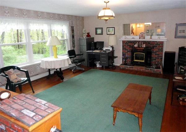 62 Old County Road Lancaster, MA 01523 - Photo 4 of 16 a living room with furniture a fireplace and a large window