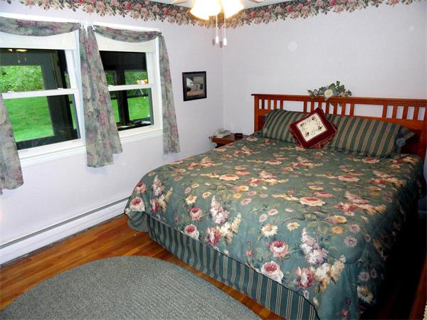 62 Old County Road Lancaster, MA 01523 - Photo 8 of 16 a bed sitting in a bedroom next to a window