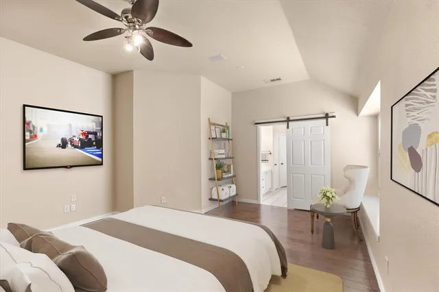 a bedroom with a large bed and a chandelier