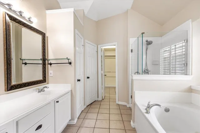 a bathroom with a tub sink and mirror