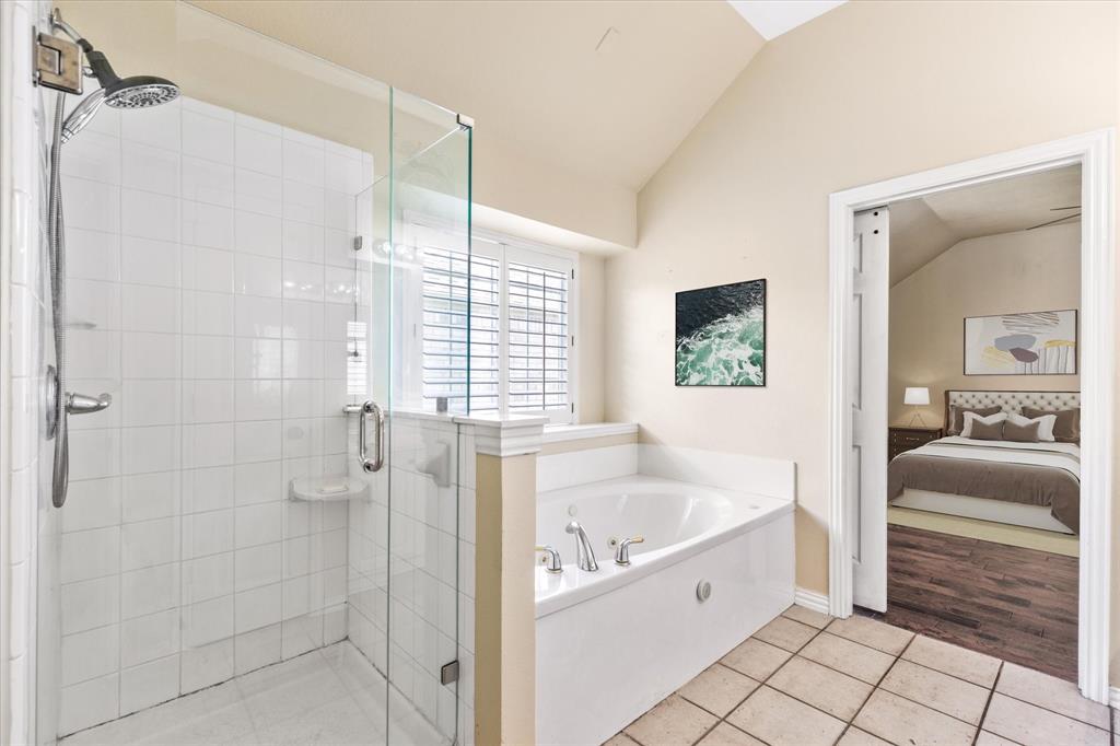 8013 Springmoss Drive Plano, TX 75025 - Photo 15 of 23 a bathroom with a bathtub and a shower
