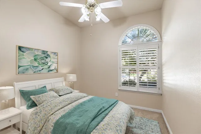 a bedroom with a large bed and a window