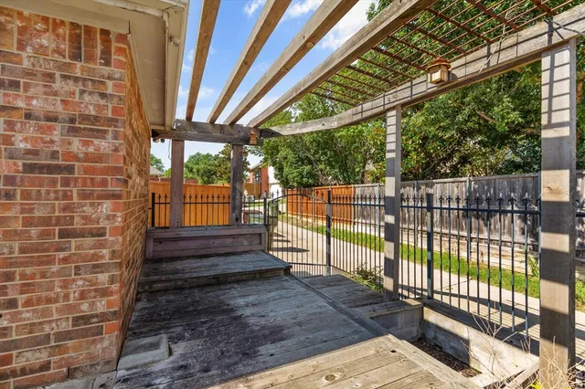 a view of a porch with wooden floor and iron stairs