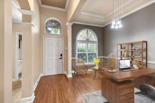 a living room with furniture and wooden floor