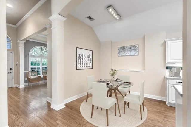 a view of a dining room with furniture and wooden floor