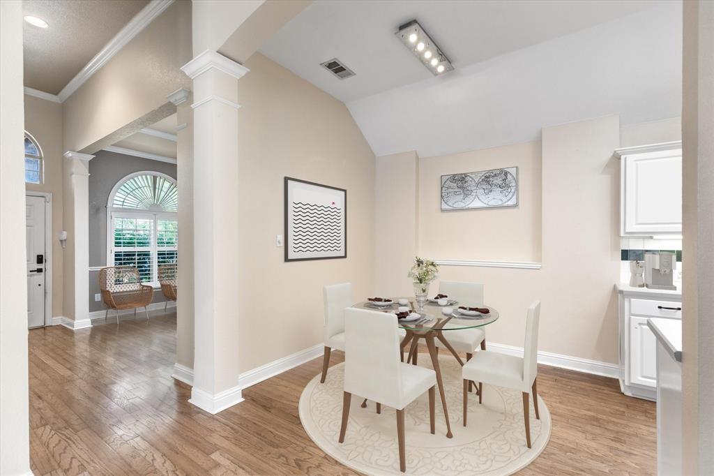 8013 Springmoss Drive Plano, TX 75025 - Photo 6 of 23 a view of a dining room with furniture and wooden floor
